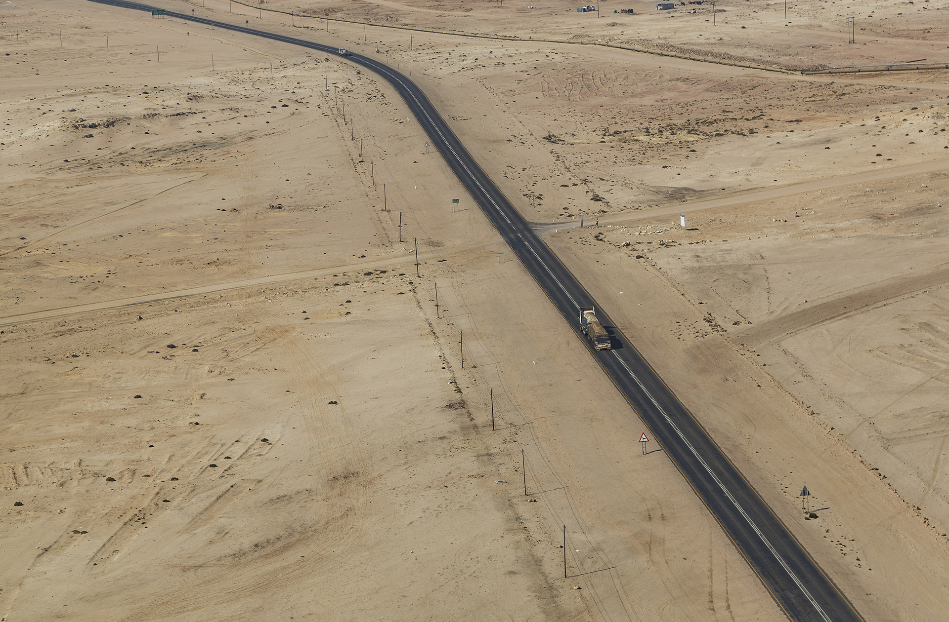 Strada asfaltata che attraversa un deserto.