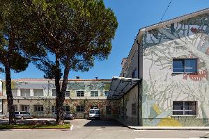 spazio aperto con alberi e facciata di Irisacqua